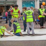 Project Manager Fiona Sturley and volunteers lay the performance matting in the Market Place