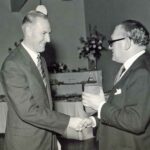 George Cottrell (left) receiving his 25 year service clock from Mr. Rubython, Hawker Aircraft Director, 1959.